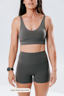 Front view of the Elevate Crop in stone, featuring a soft neutral tone and flattering sports crop silhouette
