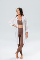 Model wearing the Elevate Leggings in mocha, styled as a matching set with a smooth high-waisted fit and ultra-soft fabric