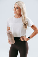 HER Cropped Taupe Tee styled over activewear for everyday wear, minimalistic neutral look