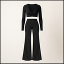 A black two-piece outfit consisting of a long-sleeve cropped top with a twisted front detail and matching high-waisted flared pants, displayed as flat lay