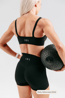 Back view of the Perform Contour Crop in onyx, showing the minimalist square strap silhouette and supportive fit