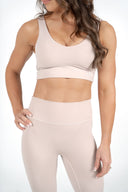 Aura Crop in taupe, showcasing the clean square back and soft sculpting fit-HER logo front left side