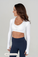 Perform Bolero Twist Top white layered over women’s active crop top for training 