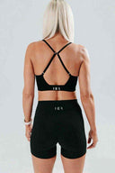 Back view of the Elevate Crop in onyx, showing the cross-back adjustable strap design