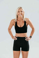 Front view of the Elevate Crop in onyx black, highlighting the clean silhouette and supportive underband