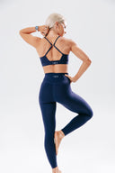 Back view of the Elevate Crop in royal navy, highlighting the supportive cross-back design
