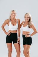 Two models wearing elevate crop and perform shorts as best selling activewear set for hiit or performance training