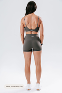 Back view of the Elevate Shorts in stone, showcasing the supportive waistband and clean, minimal activewear design