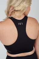 Back detail of the Empower Crop on a large model, demonstrating inclusive fit, coverage and high-support design