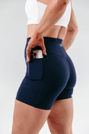 Perform Pocket Shorts in Navy – sculpting women’s active shorts with pocketsside view