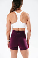 Back view of the Perform Shorts in plum, highlighting the Invisible Scrunch for a natural sculpted look